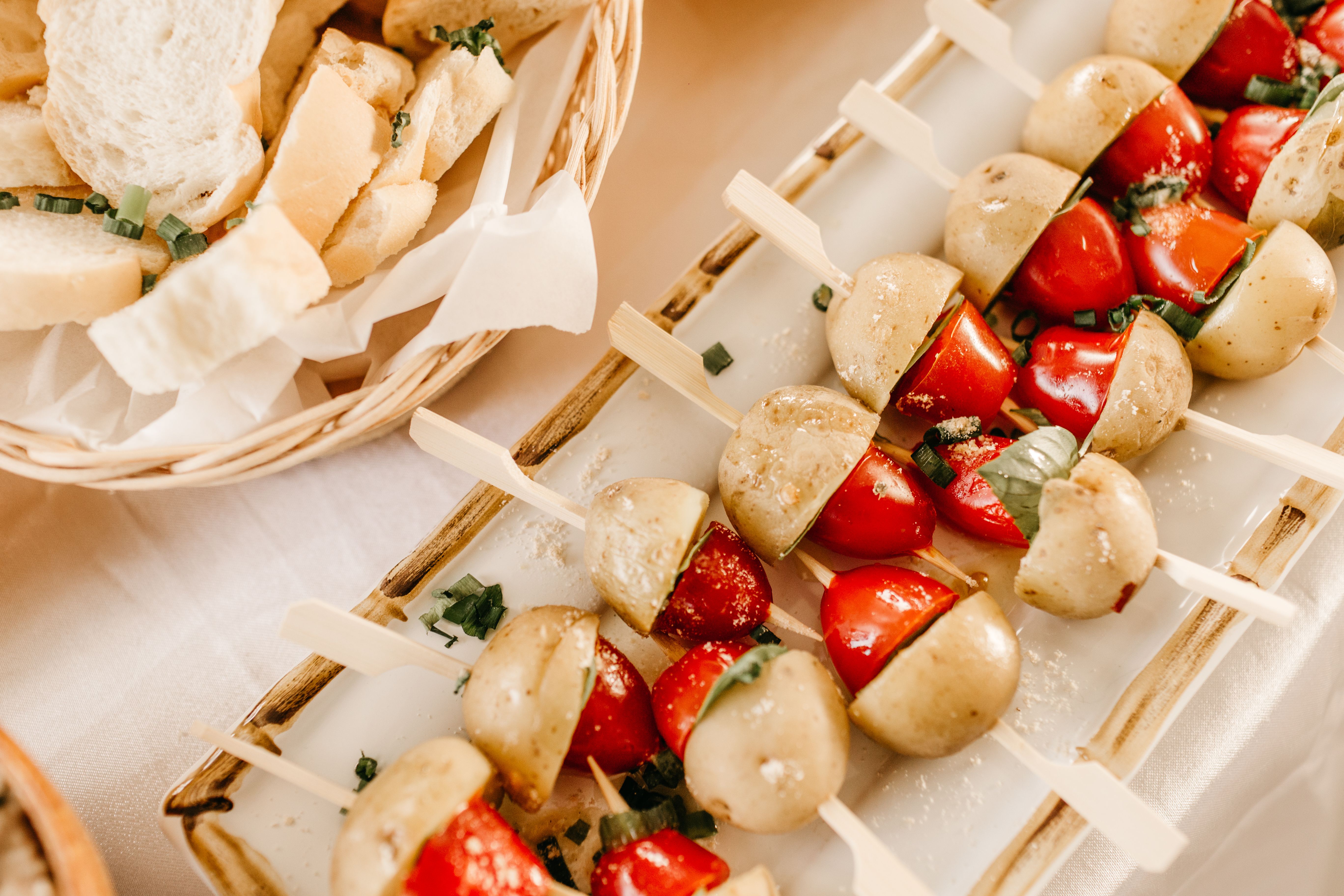 Vegan skewers featuring potatoes and tomatoes, perfect for appetizers.