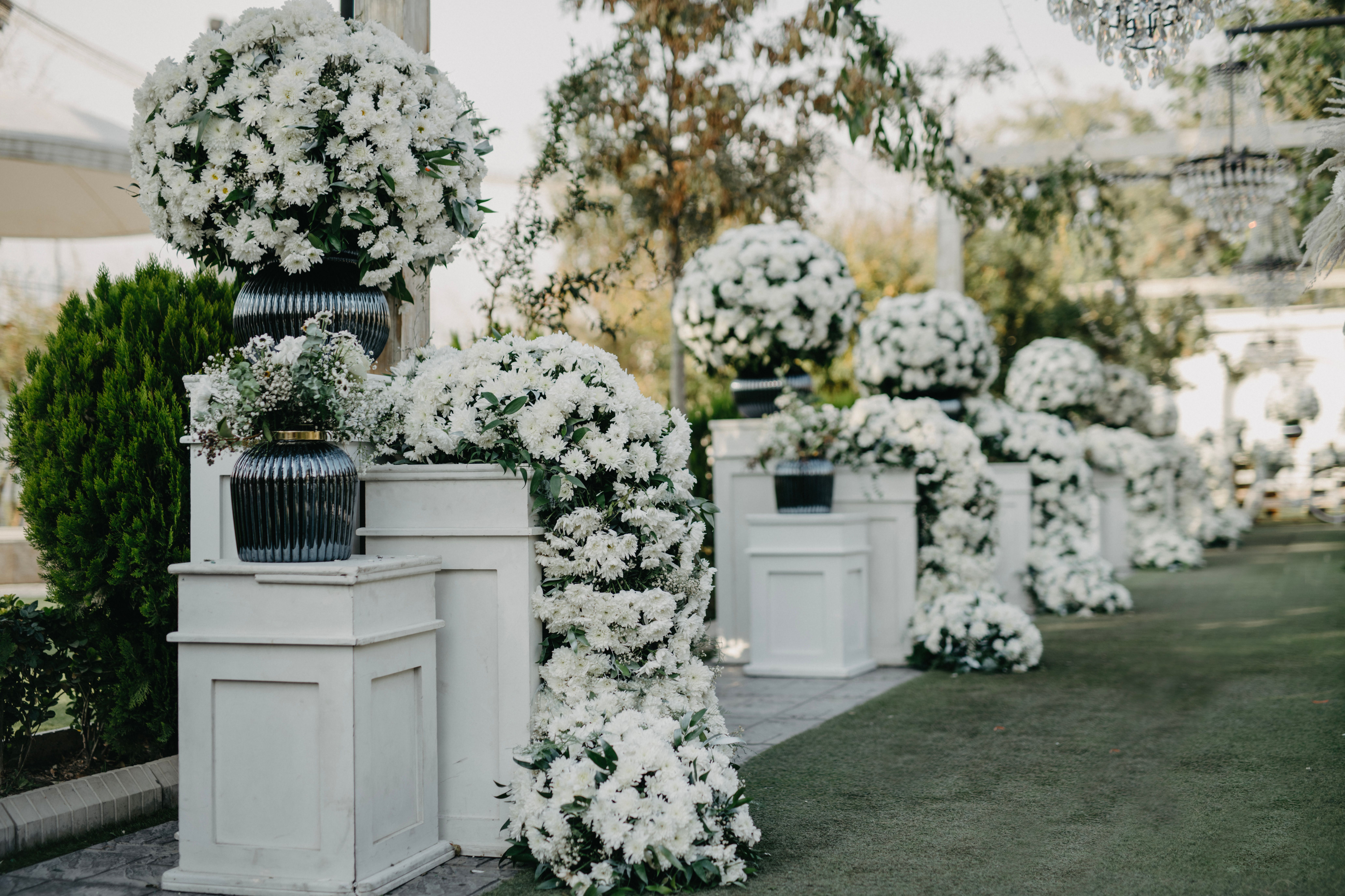 Beautiful white floral arrangements in an outdoor setting perfect for weddings.