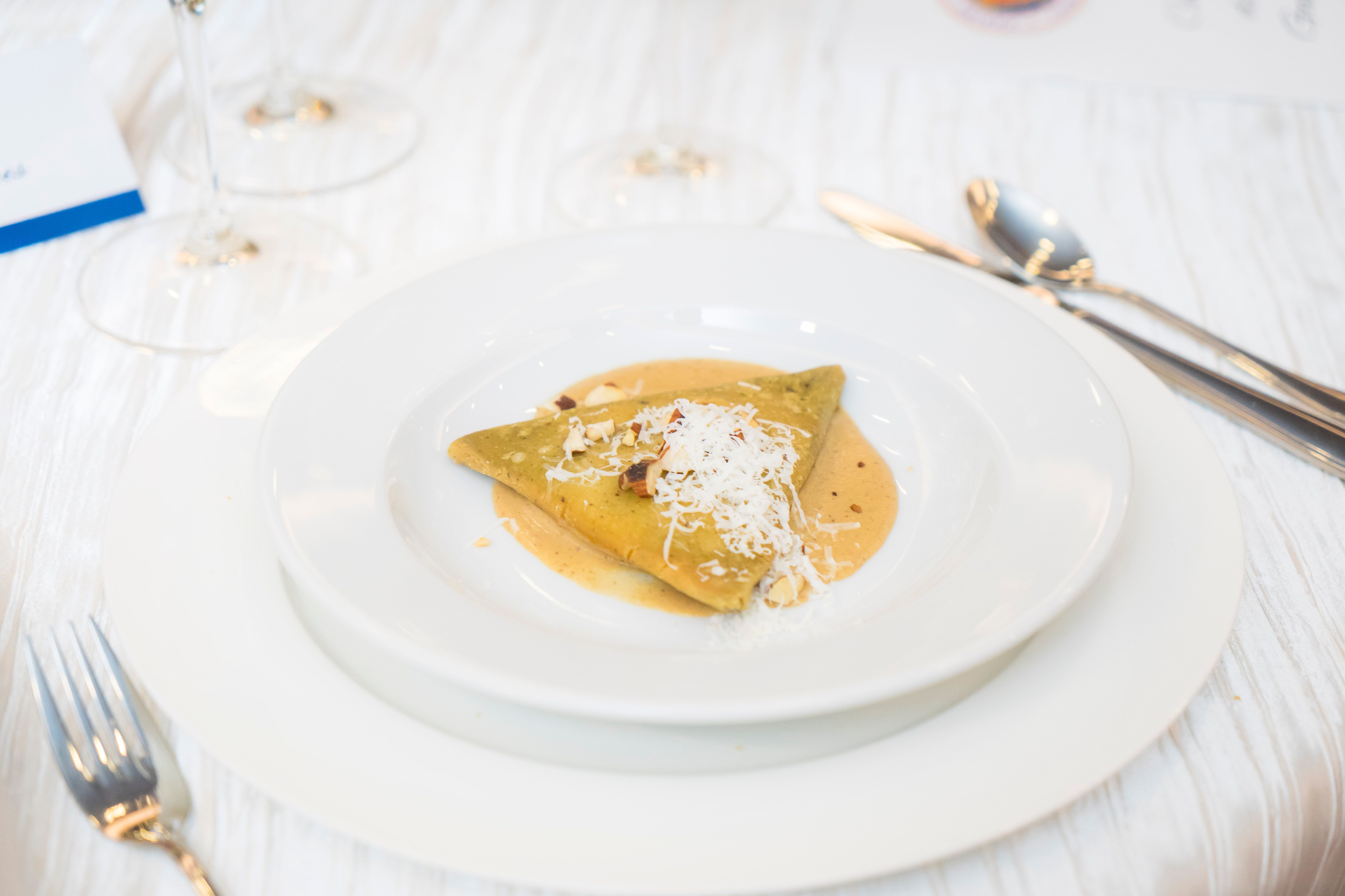 Delicious gourmet dish served elegantly with cheese garnish, perfect for culinary enthusiasts.