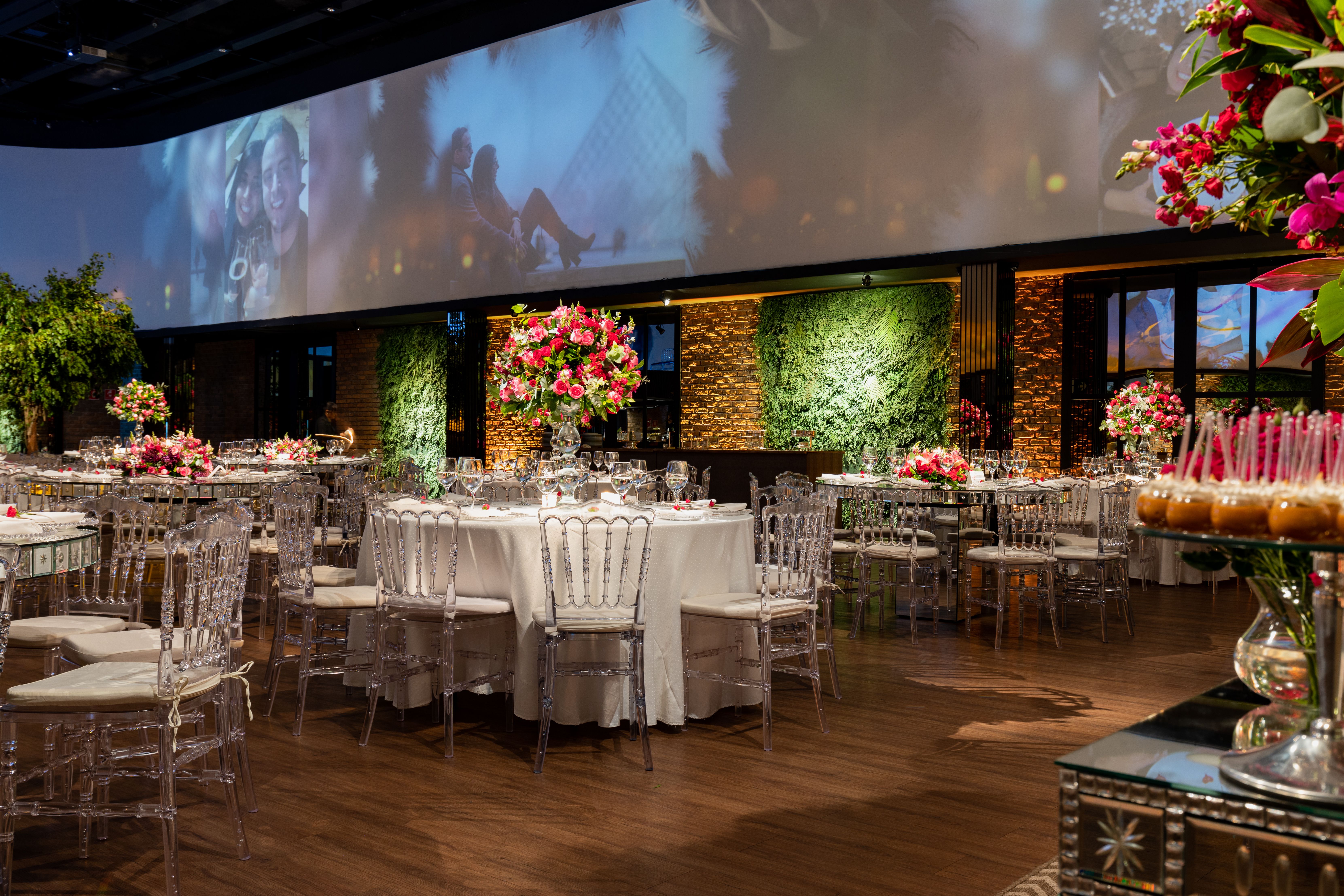 A beautifully decorated indoor event venue with vibrant floral arrangements and elegant seating.