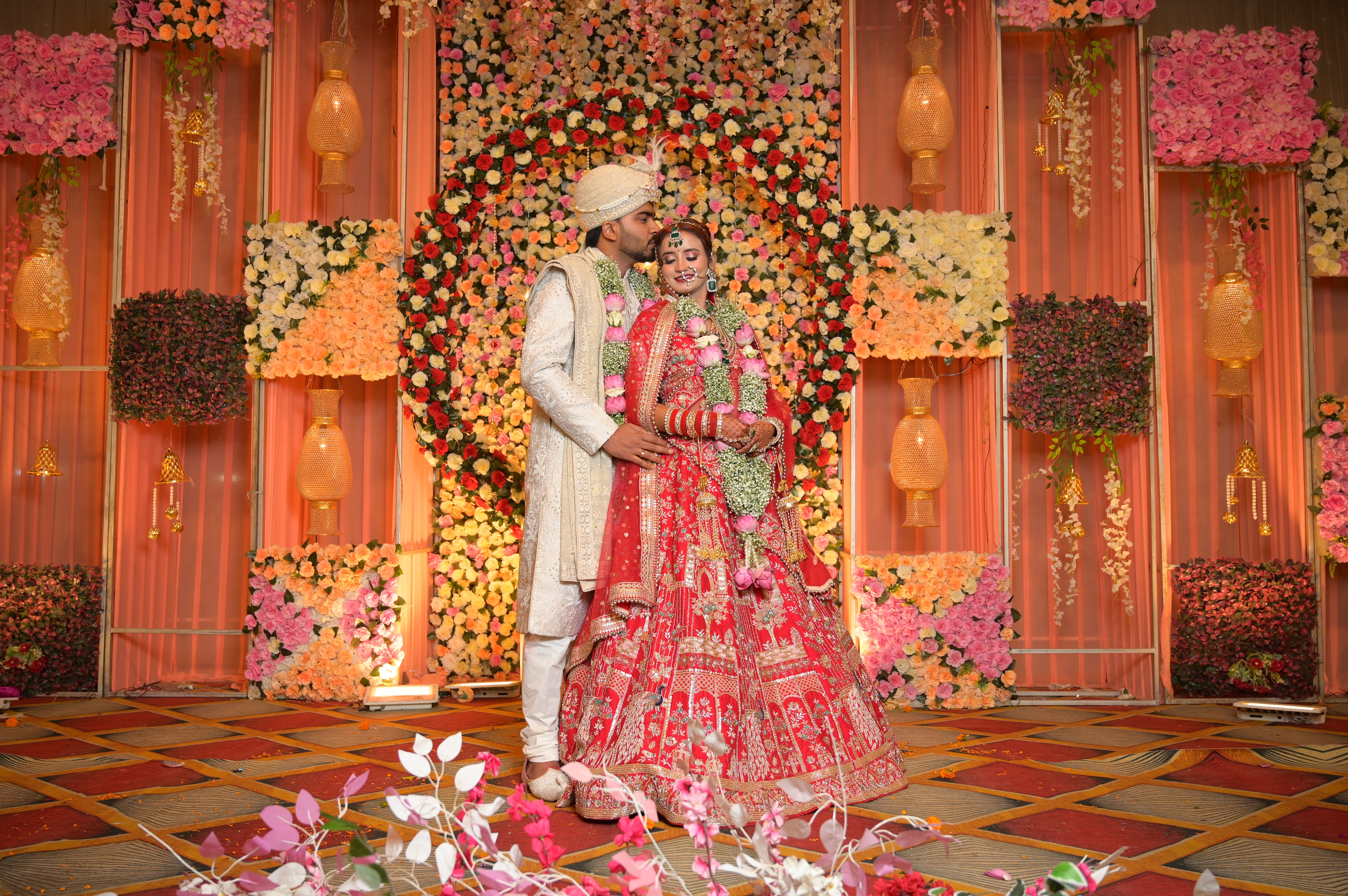 Beautiful Indian couple in traditional attire at a vibrant wedding ceremony.