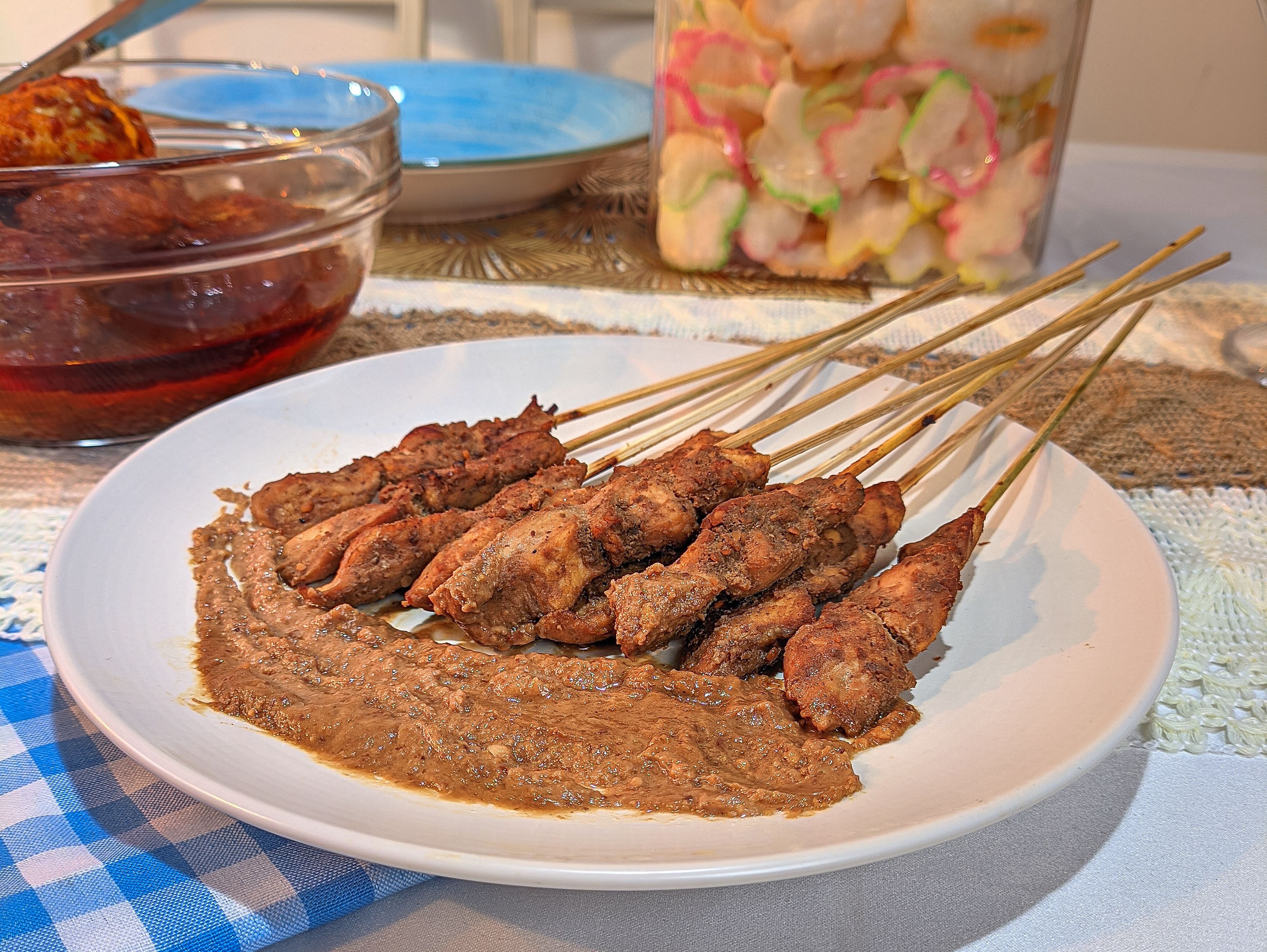 Indonesian chicken satay served with peanut sauce and traditional sides.