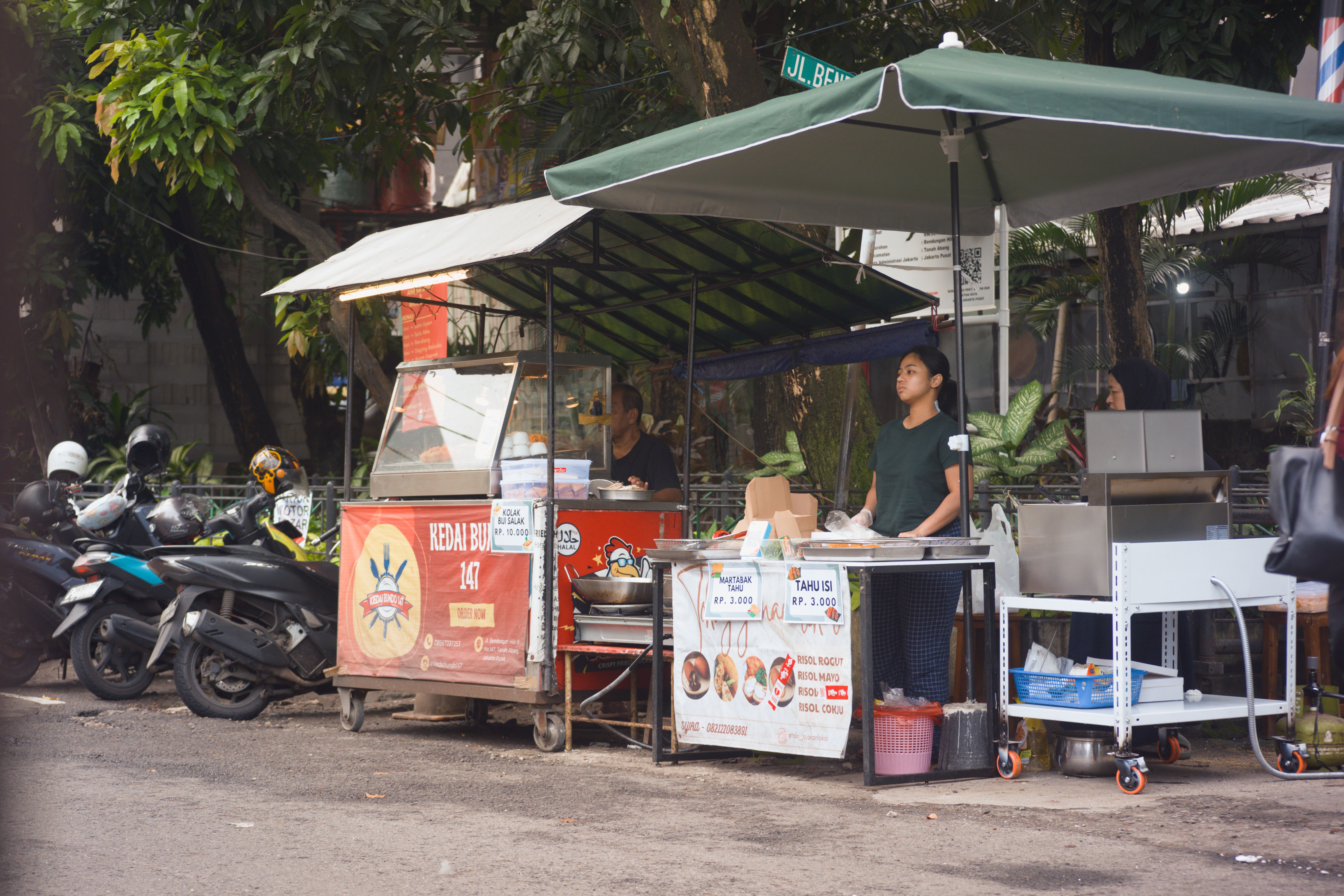 Authentic street vendor selling traditional food in Jakarta, Indonesia.