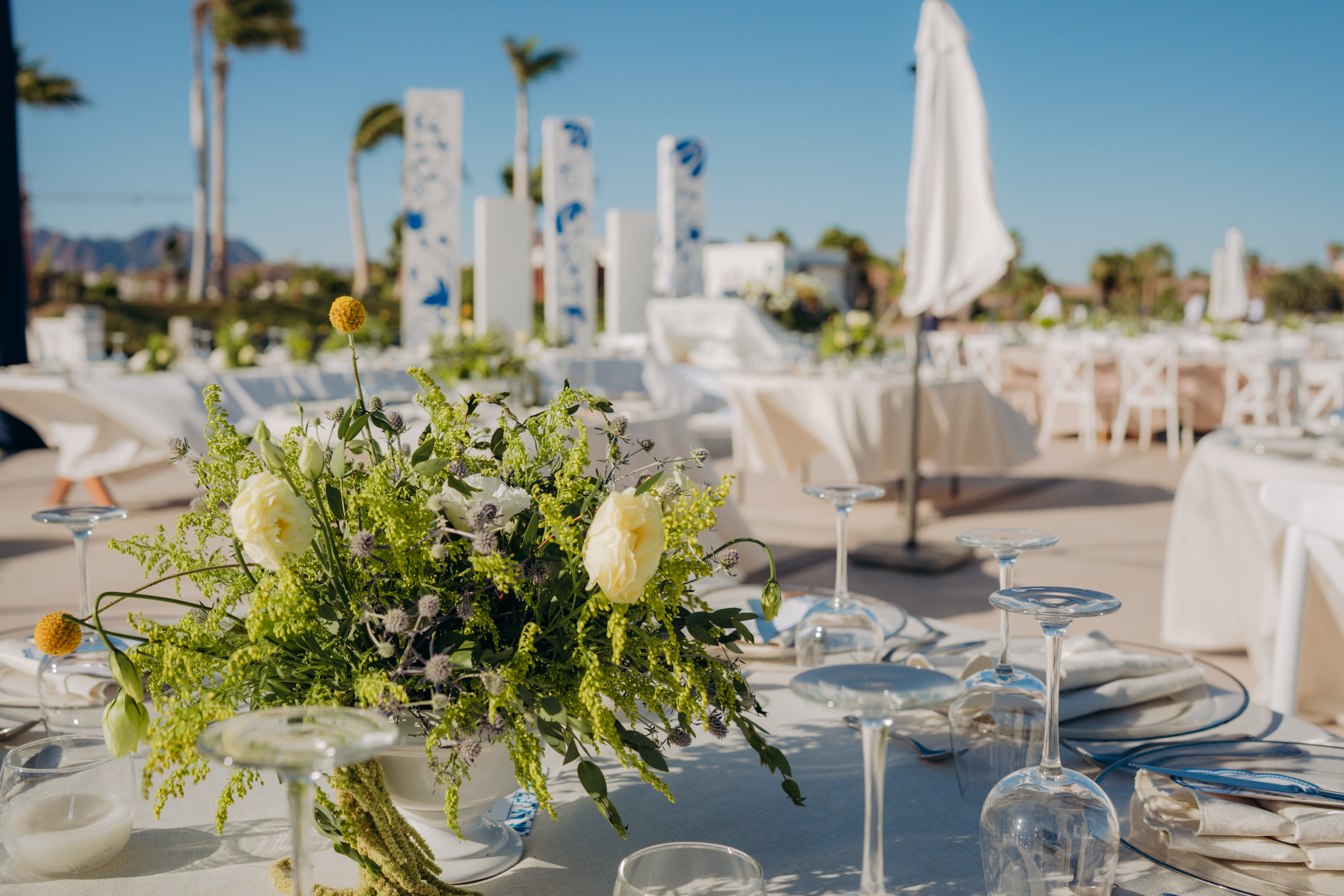 Sophisticated outdoor wedding scene with floral arrangement and elegant table setup.