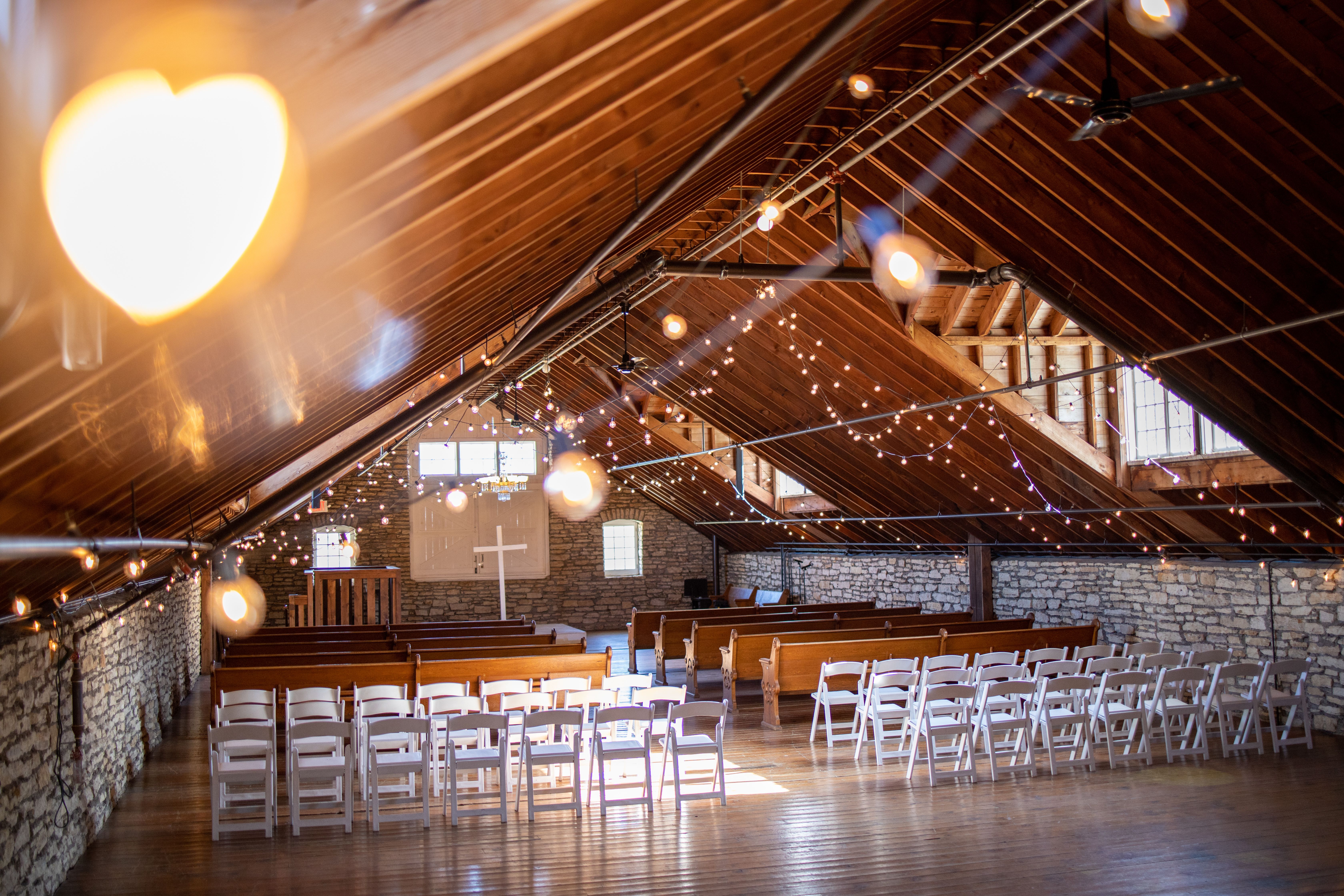 Beautiful rustic church interior with wooden beams and natural light streaming through windows.