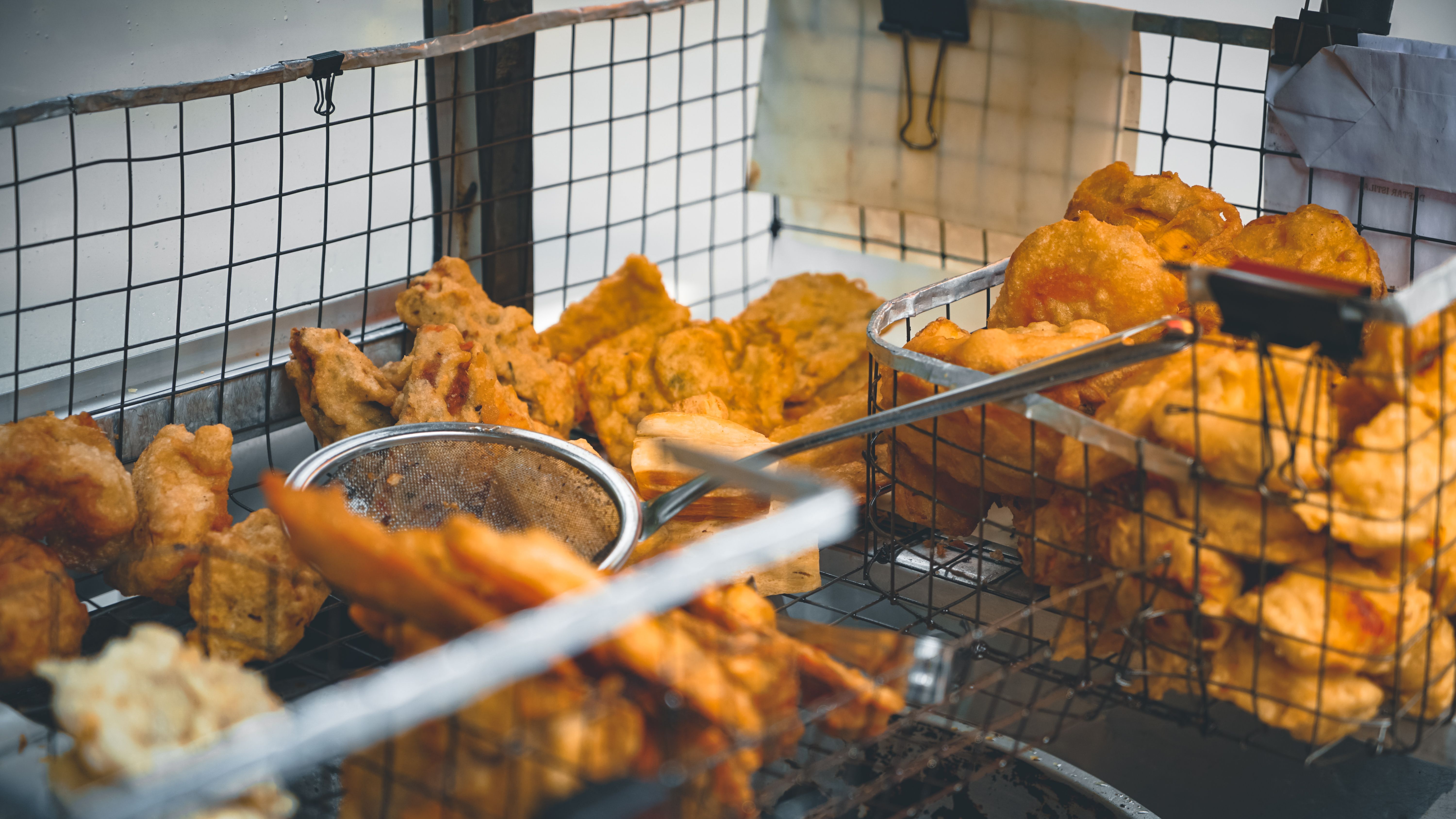 Delicious fried chicken in a street food setting in Bekasi, Indonesia.