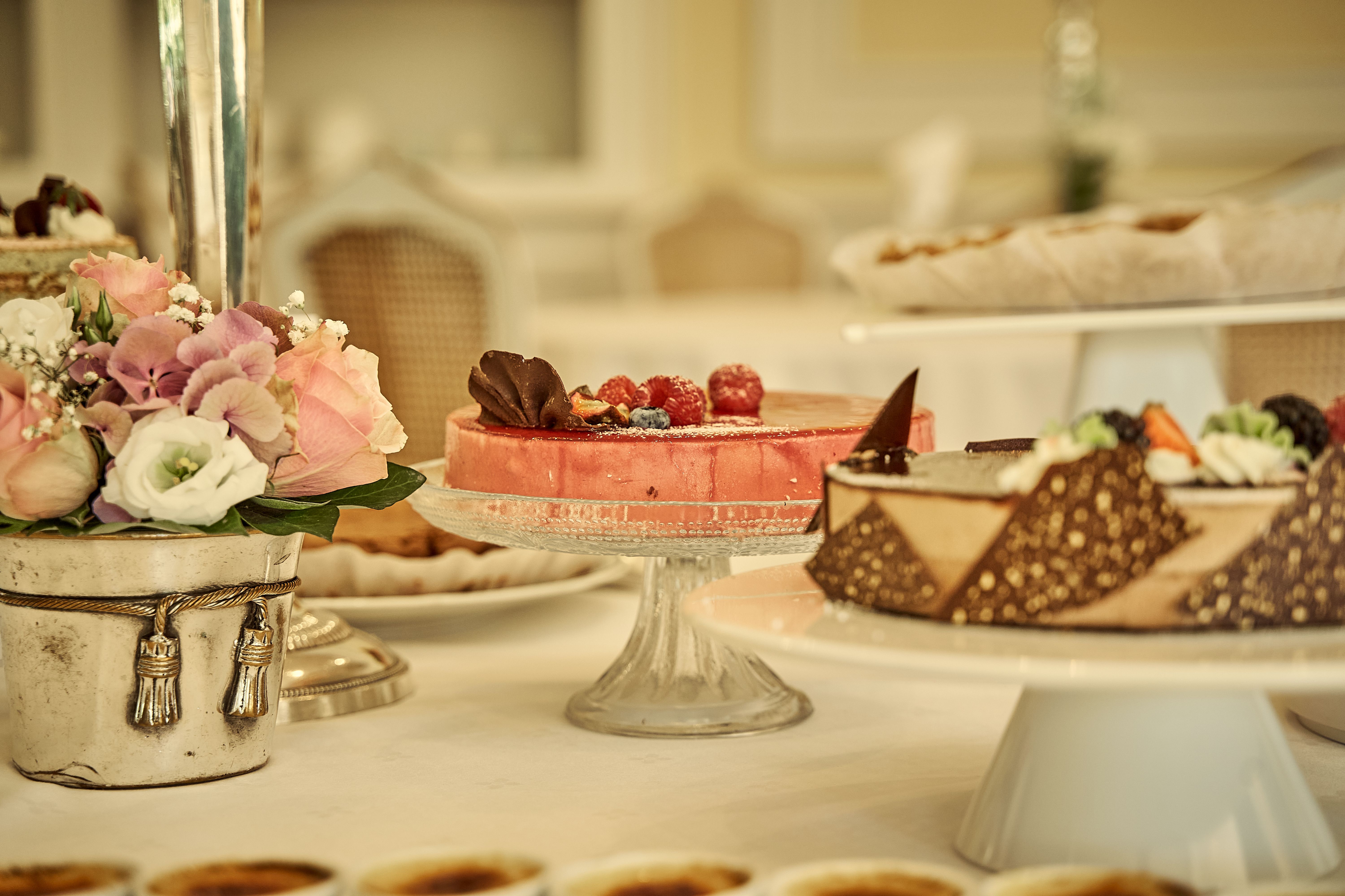 A beautifully arranged dessert table featuring cakes and floral decor. Perfect for celebrations.