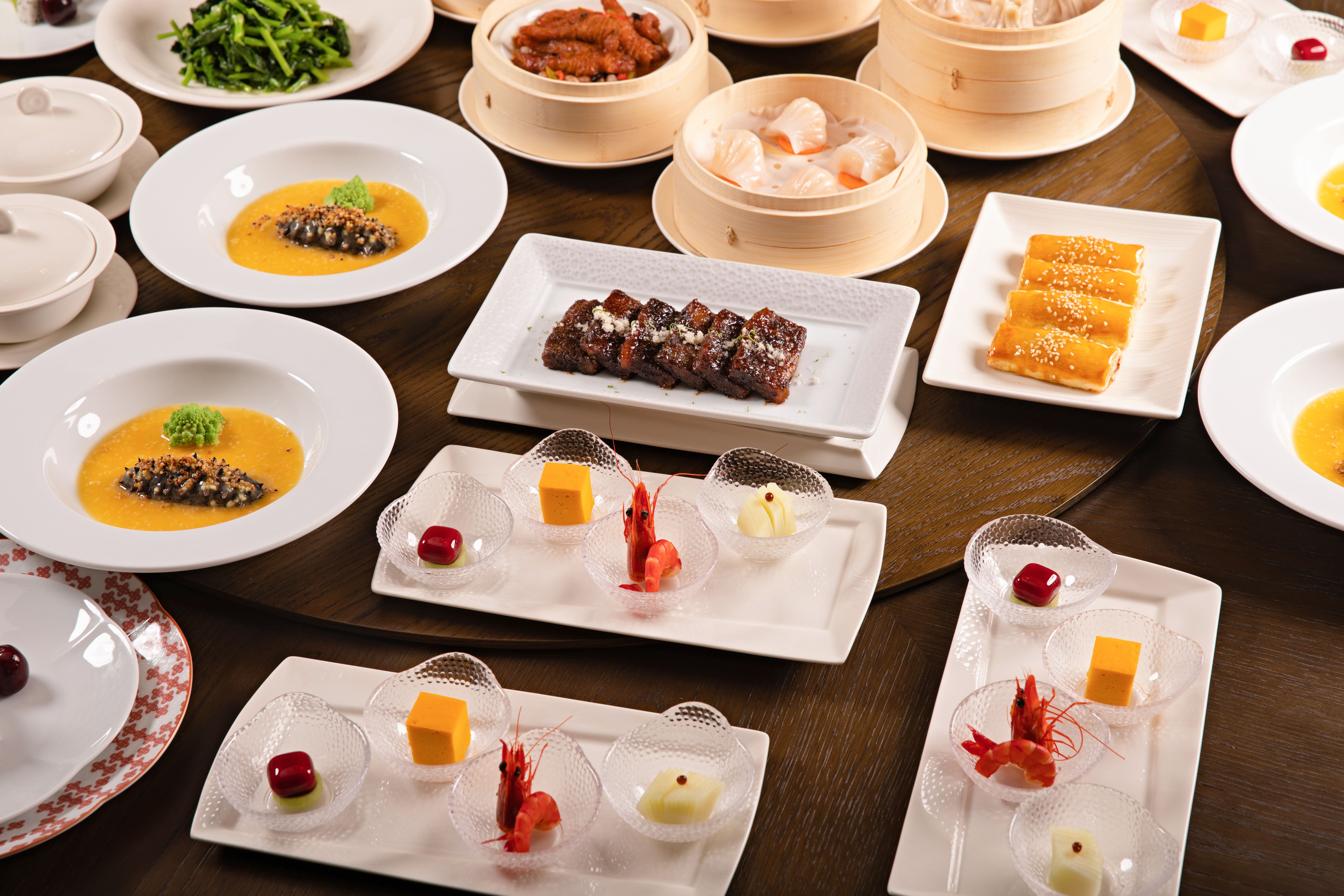 A diverse spread of Chinese dishes elegantly arranged on a round table for a gourmet dining experience.