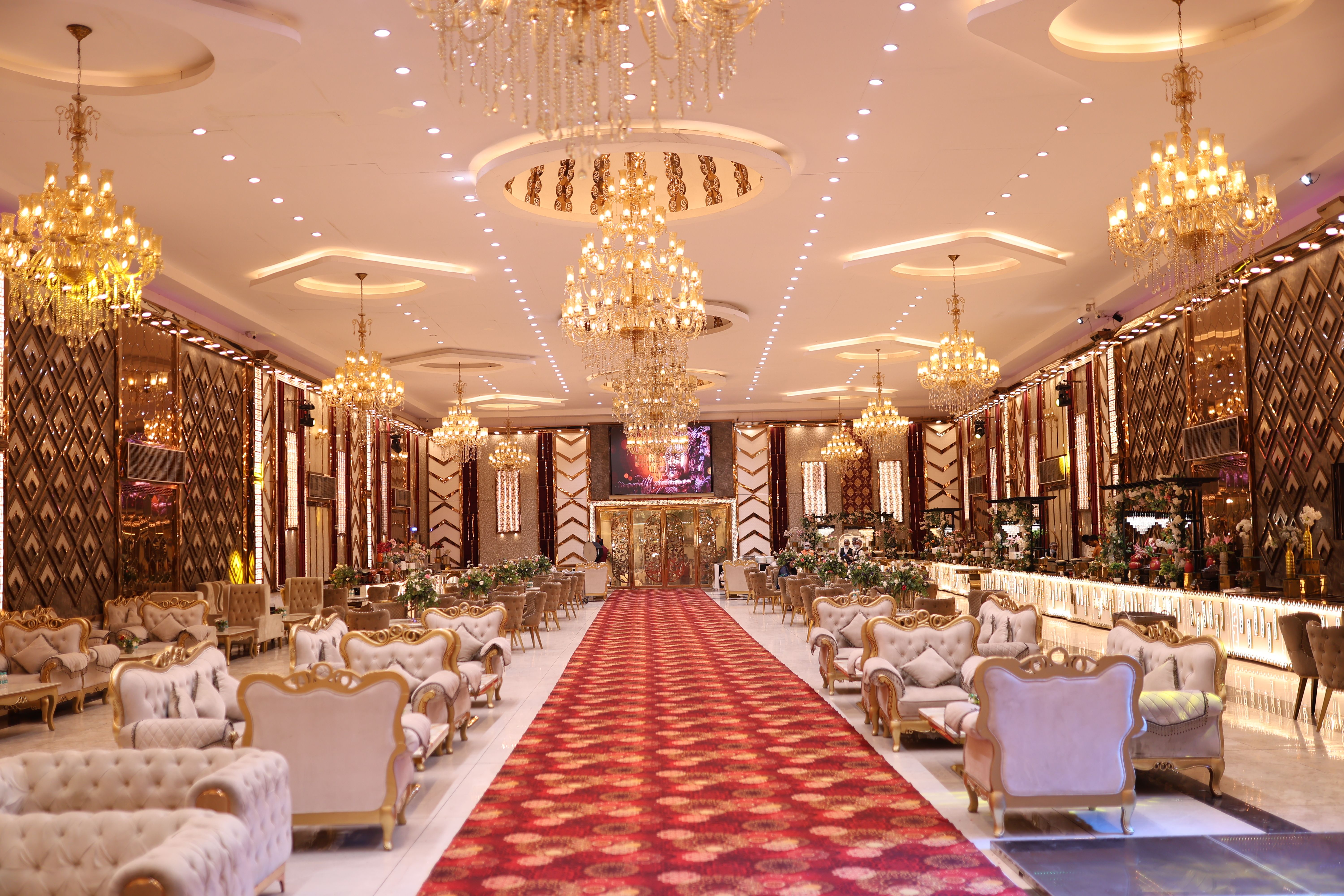 Elegant wedding hall with luxurious chandeliers and classic decor, perfect for special events.