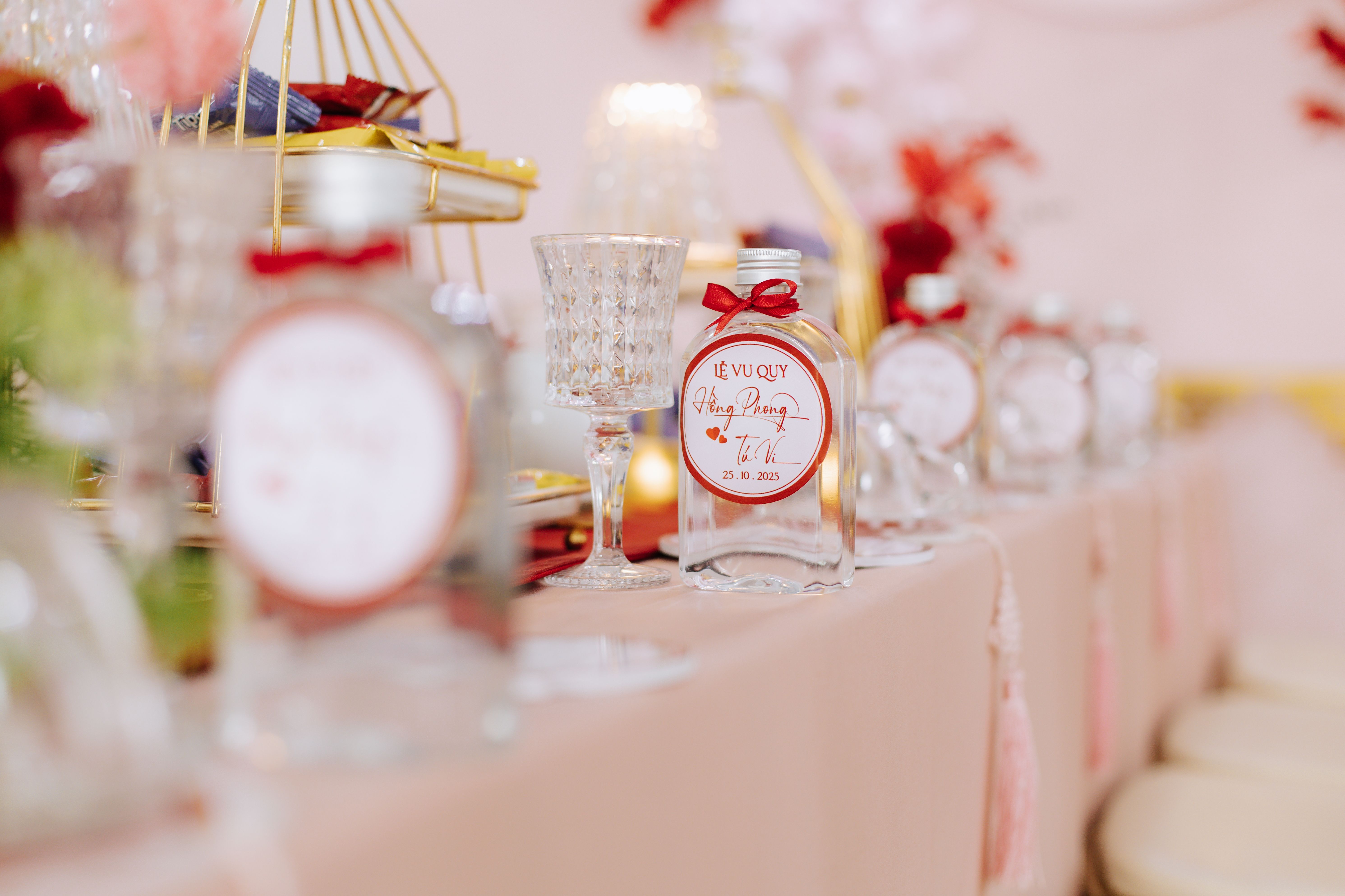 Beautifully arranged table with decorative bottles and glassware for a special event.