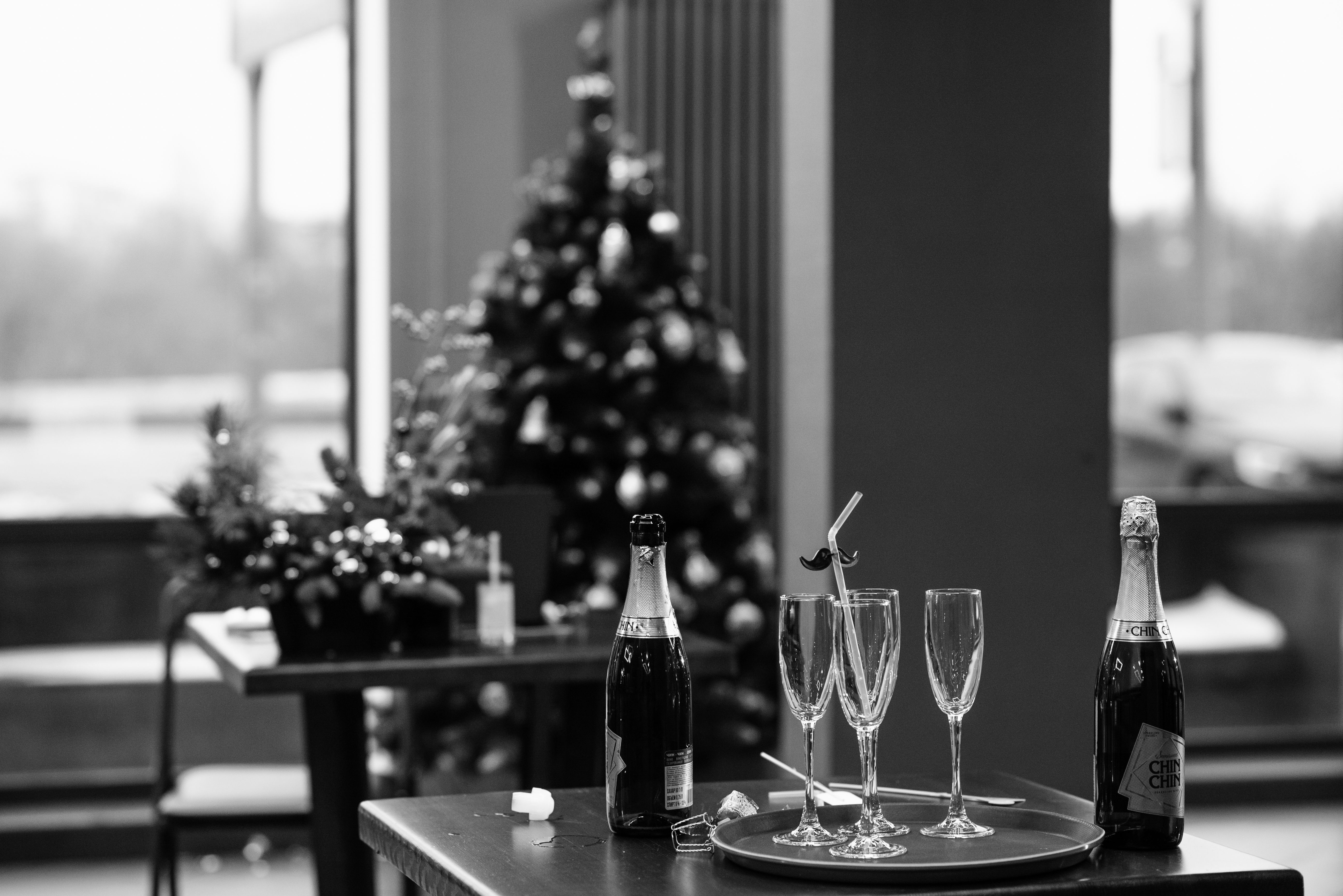 Elegant holiday setup with champagne and Christmas decorations indoors.